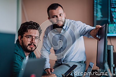 Programmers engrossed in deep collaboration, diligently working together to solve complex problems and develop Stock Photo