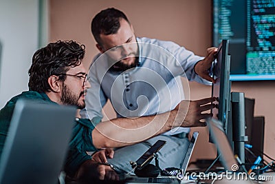 Programmers engrossed in deep collaboration, diligently working together to solve complex problems and develop Stock Photo