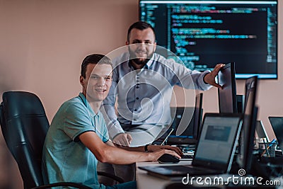 Programmers engrossed in deep collaboration, diligently working together to solve complex problems and develop Stock Photo