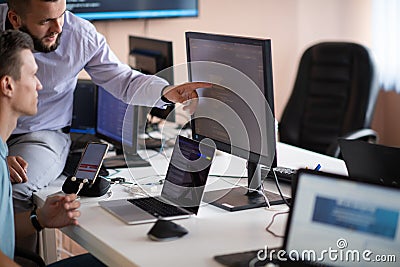 Programmers engrossed in deep collaboration, diligently working together to solve complex problems Stock Photo