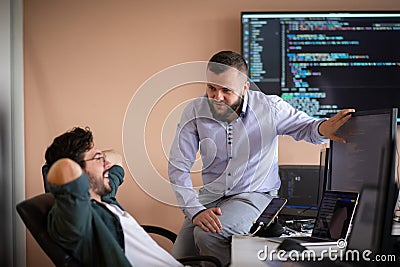 Programmers engrossed in deep collaboration, diligently working together to solve complex problems Stock Photo