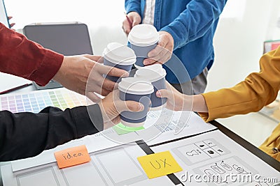 Programmers and UI ux designers have cup of hot coffee together in design studio during breaks for brain boosting coffee boost Stock Photo