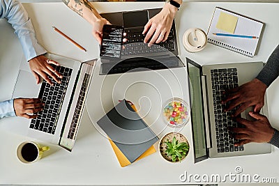 Programmers working online on computers Stock Photo