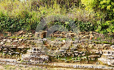 Progress - The ruins of a rubble wall built on and around the base of ancient columns from Greek Temples Stock Photo