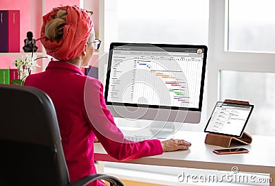 Project manager working on computer in the office. All screen contents are made up Stock Photo