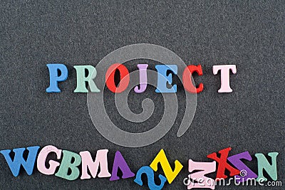 PROJECT word on black board background composed from colorful abc alphabet block wooden letters, copy space for ad text. Learning Stock Photo