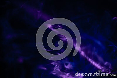 Projector spotlight purple color , abstract smoke texture background . light beam screening and glowing in dark black room at Stock Photo