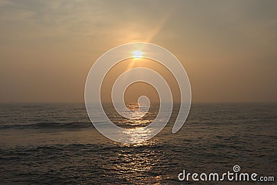 Promenade beach in Puducherry - sunrise - golden hues in sky - reflection in water - India tourism Stock Photo