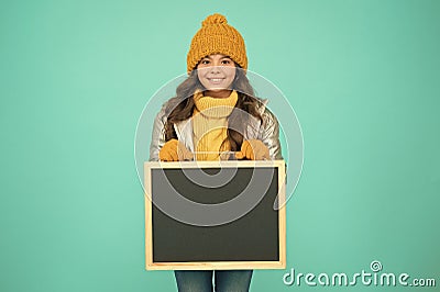 Promoting product. Child promoting event. Promotion concept. Kid cheerful promoting. Smiling girl wear winter outfit Stock Photo