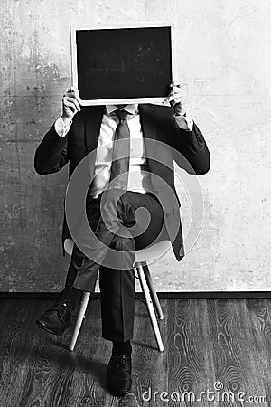 Promotion. businessman holding a blackboard, promotion. businessman holding a blackboard. Stock Photo