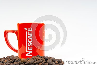 Promotional red Nescafe mug on white background Editorial Stock Photo