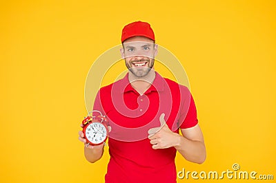 Promptness and punctuality. Delivery time. Delivery courier with clock. Delivery man holding clock. Shipping services Stock Photo