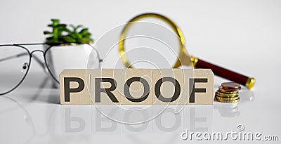 PROOF concept on wooden cubes and flower ,glasses ,coins and magnifier on the white background Stock Photo