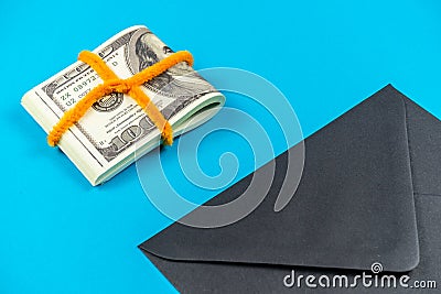 Prop Money Dollars and black envelope.Light blue background Stock Photo