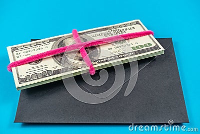 Prop Money Dollars and black envelope.Light blue background Stock Photo