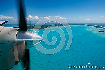 Propeller airplane detail flying in tropical paradise Stock Photo