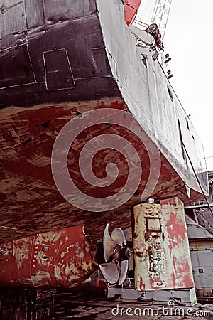 Propeller of cargo ship. Dry dock. View from stern. Rusty. Before repeating work Stock Photo