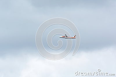 Propeller plane, ATR 72-600, of the Iberia airline flying in a sky with dark clouds shortly after take off Editorial Stock Photo