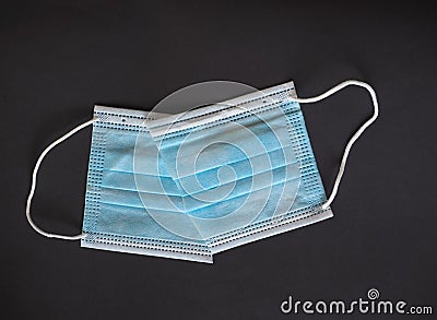 Proper disposal of used medical mask cut to prevent reuse Stock Photo