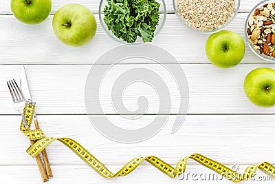 Diet for weight loss concept with measuring tape, greenary and oat on white background top view copy space Stock Photo