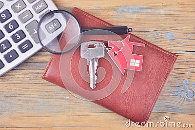 Property assessment. Miniature house with key, magnifier and calculator. Real estate concept Stock Photo