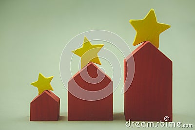 Property assessment and rate with a star. Three size red house with yellow stars on the roof for selection of the best house Stock Photo