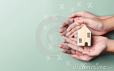 Property interest research best rate, Hands holding wood house, finance loan increase.investment planning.business real estate. Stock Photo