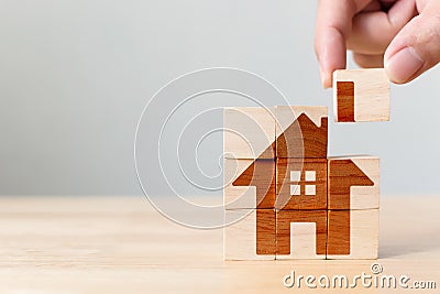 Wooden cube block puzzle with home image Stock Photo