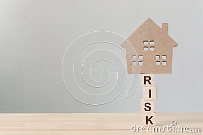 Property investment and house mortgage financial. Risk management concept. Wooden home on wood block Stock Photo