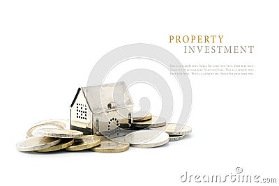 Property investment, silver golden house model on coins isolated Stock Photo
