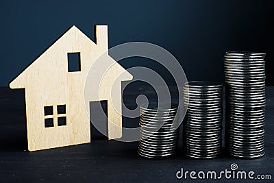 Property investment and value of home. Coins and model of house Stock Photo