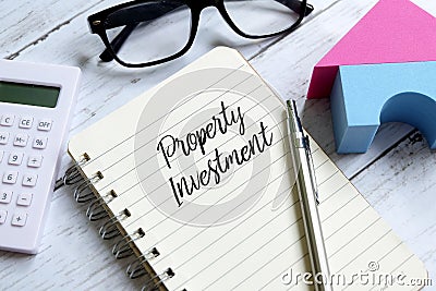 Property investment written on a notebook. Business and finance concept Stock Photo