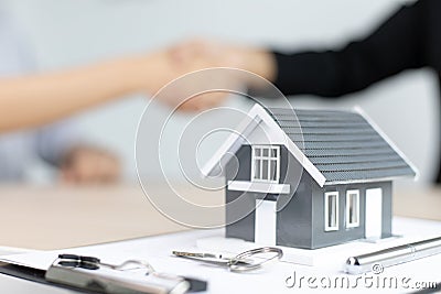 Property manager Shake hands with congratulations on the customers who bought the house with insurance Stock Photo