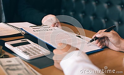 Property sales staff submit land mortgage contract documents to home buyers for sign Stock Photo