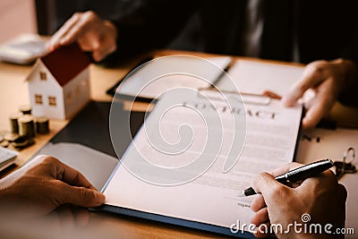 Property sales staff submit land mortgage contract documents to home buyers for sign Stock Photo