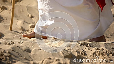 Prophet legs walking on sand, following of Jesus faith, religious conversion Stock Photo