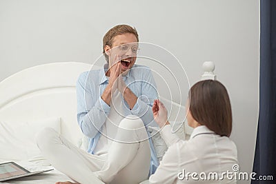 Proposal of woman asking man to marry her in bedroom. Man getting happy and excited at his girfriends proposal indoors Stock Photo