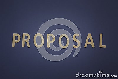 Proposal written with wooden letters on a blue background Stock Photo