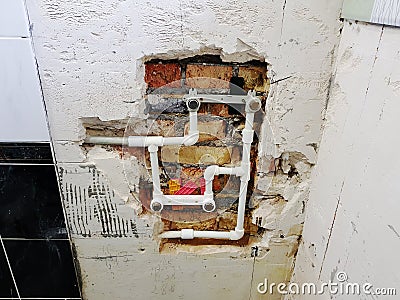 Propylene pipe and gates in a brick wall - propylene welding Stock Photo