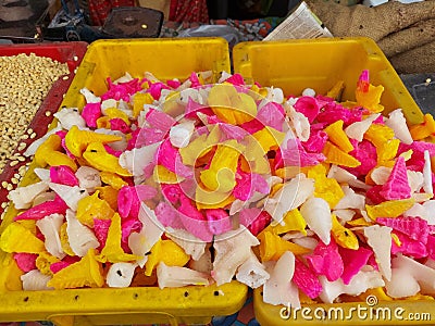 Prosad a typical colourful sweets of diwali made from cane sugar selling at kolkata footpath along with ladu. Stock Photo