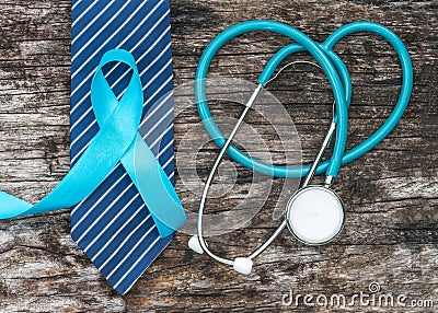 Prostate cancer awareness concept with light blue ribbon on necktie and old aged wood for men`s health care campaign in November Stock Photo