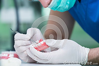 Prosthetics hands while working on the denture. Stock Photo