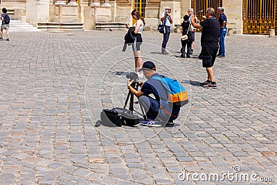 Prosumer tourist photographer taking picture at Versailles Editorial Stock Photo