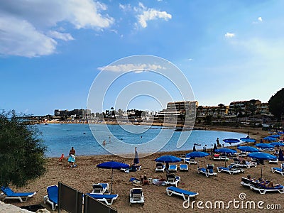 Protaras. Famagusta area. Cyprus. Sandy Kalamies beach with sun loungers and parasols in the bay of the Mediterranean Sea in the Editorial Stock Photo