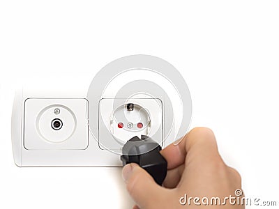 Protected grounded electrical outlet on the wall and antenna socket Stock Photo