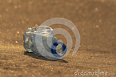 Protecting environment and caring for planet Earth. Plastic bottle on the beach. Ocean pollution concept. Copy space Stock Photo