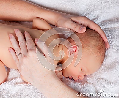 Protecting hands on a baby Stock Photo