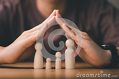 Protecting Hands Over wooden Family, Family Protection And Care Concept, family home, foster care, Stock Photo