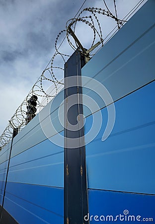 Protection fence with barbed wire for surface subway protection Stock Photo
