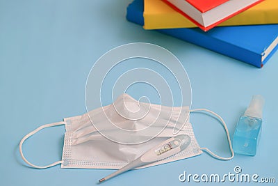 Protection products against the COVID-19 virus. Surgical mask, thermometer, disinfectant gel. Coronavirus or covid-19 concept. Stock Photo